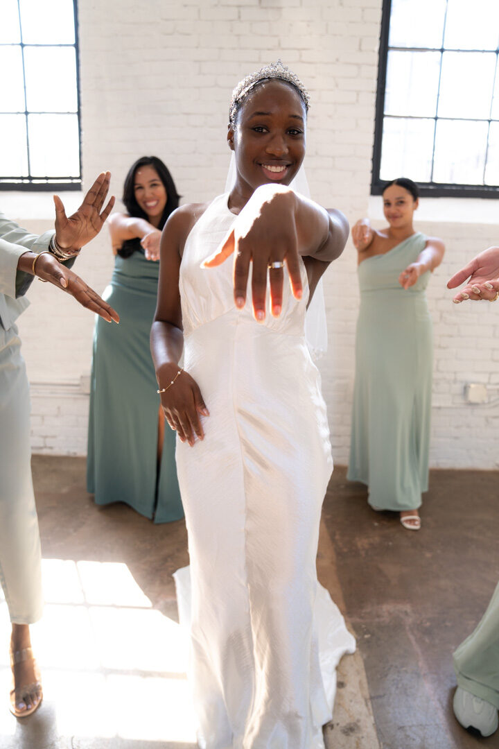 Bride dancing joyfully with bridesmaids at wedding reception