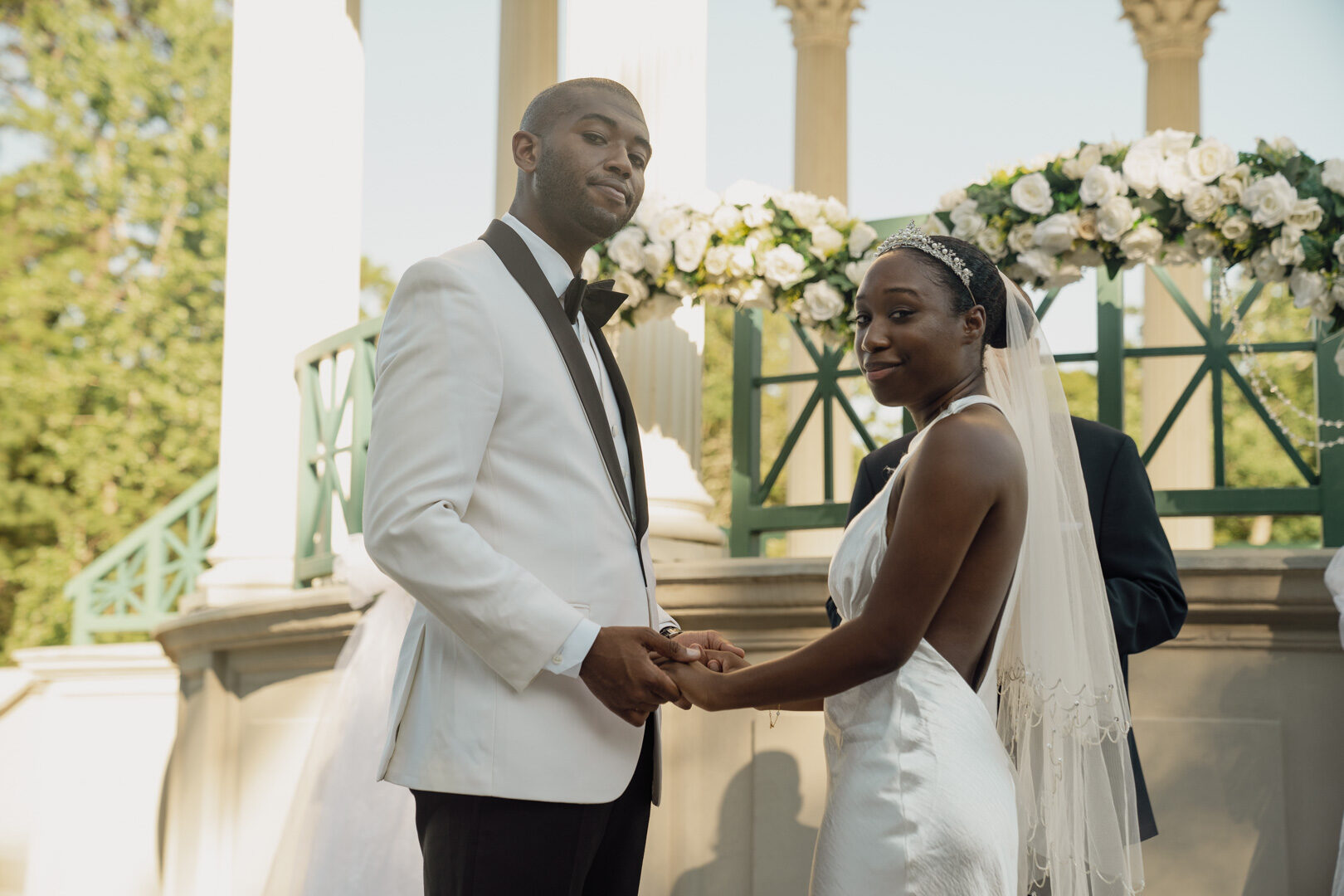 Bride and groom holding hands during their wedding ceremony vows