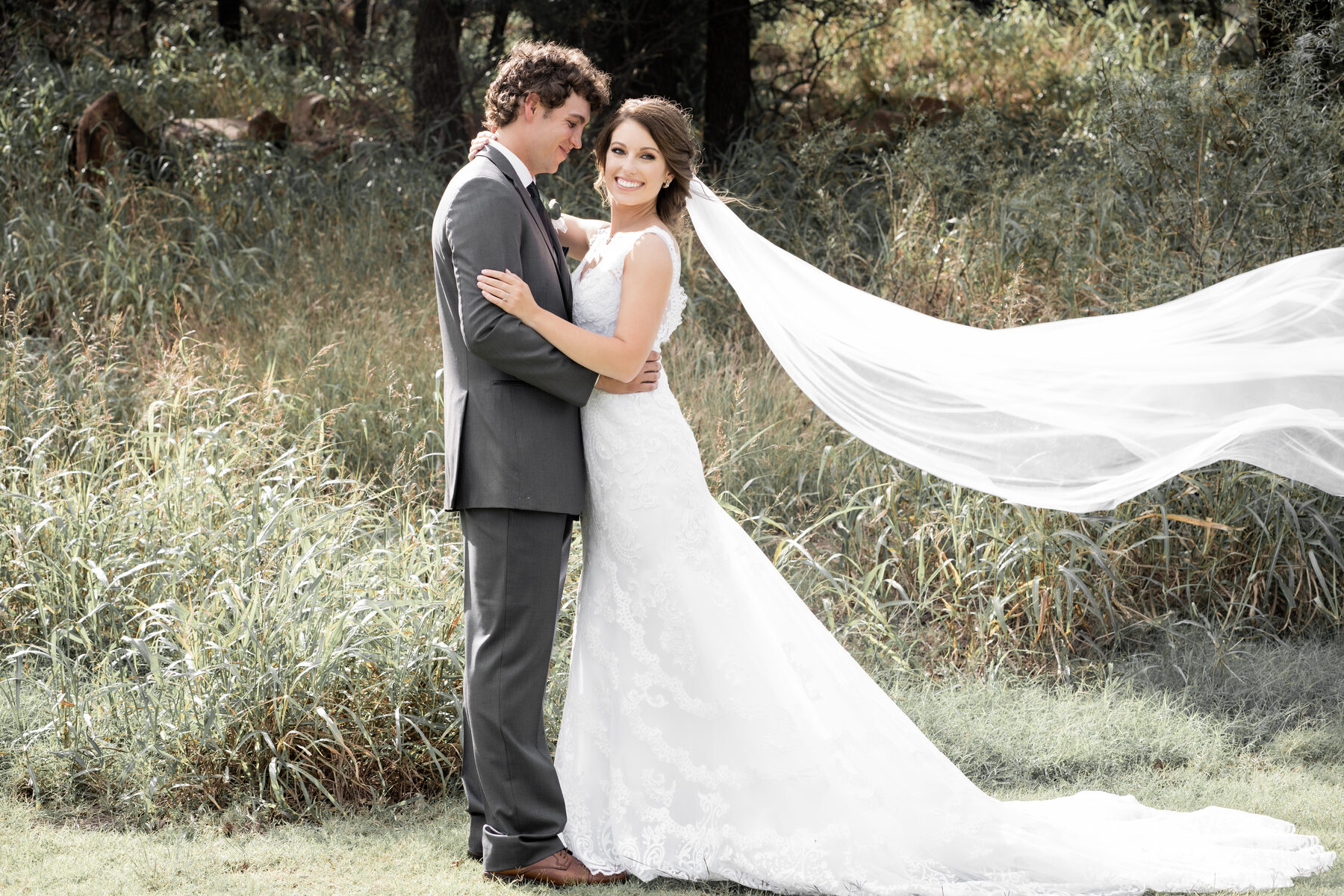 Bride and groom portrait in a golden wheat field at sunset