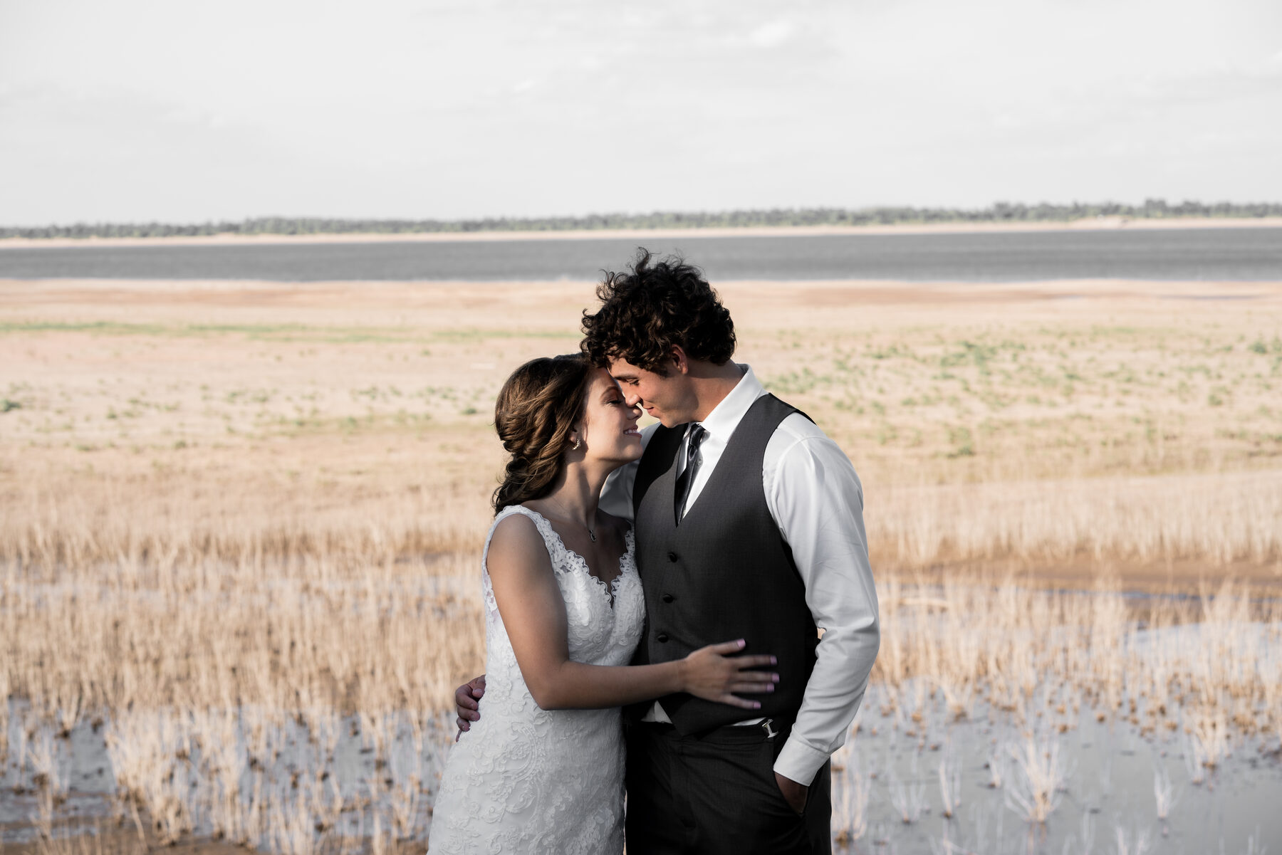 Bride and groom foreheads together in an intimate wedding portrait